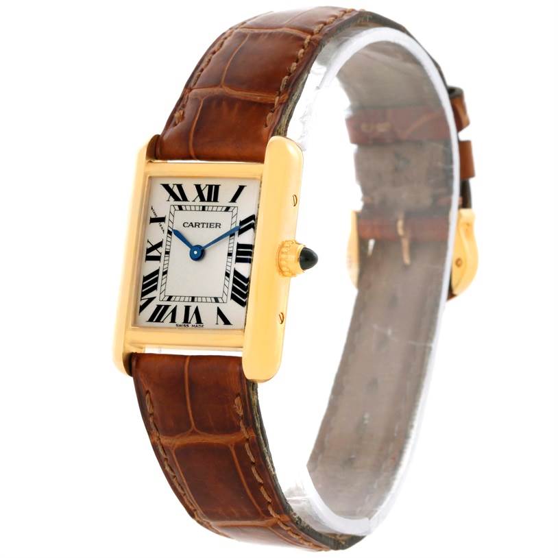 The Cartier Tank Louis W1529856 Women's Yellow Gold Silver Dial W1529856 Women's Yellow Gold Silver Dial watch is shown at a slight side angle, displaying its rectangular dial, Roman numerals, and brown leather strap.