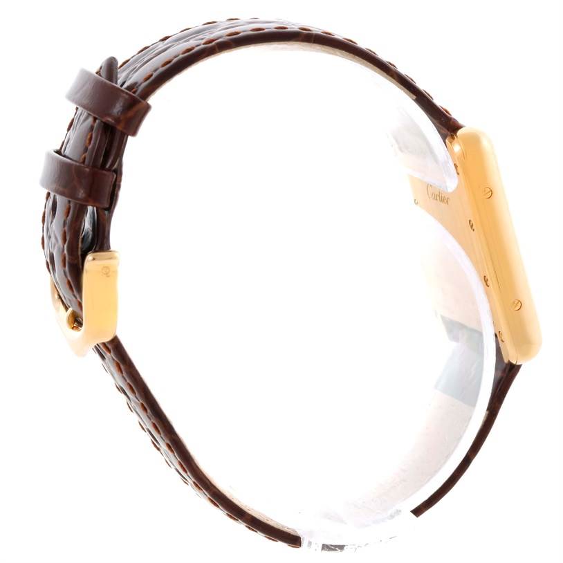 The image shows a side view of the Cartier Tank Louis W1529856 Women's Yellow Gold Silver Dial W1529856 Women's Yellow Gold Silver Dial watch, highlighting the brown leather strap and gold watch case.