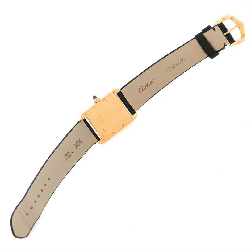 The image shows the back view of a Tank Louis model by Cartier, displaying the strap, buckle, and case back.