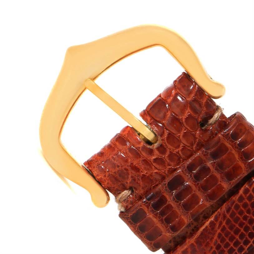 This image shows a close-up of the buckle and leather strap of a Cartier Tank Louis W1529856 Women's Yellow Gold Silver Dial W1529856 Women's Yellow Gold Silver Dial watch.