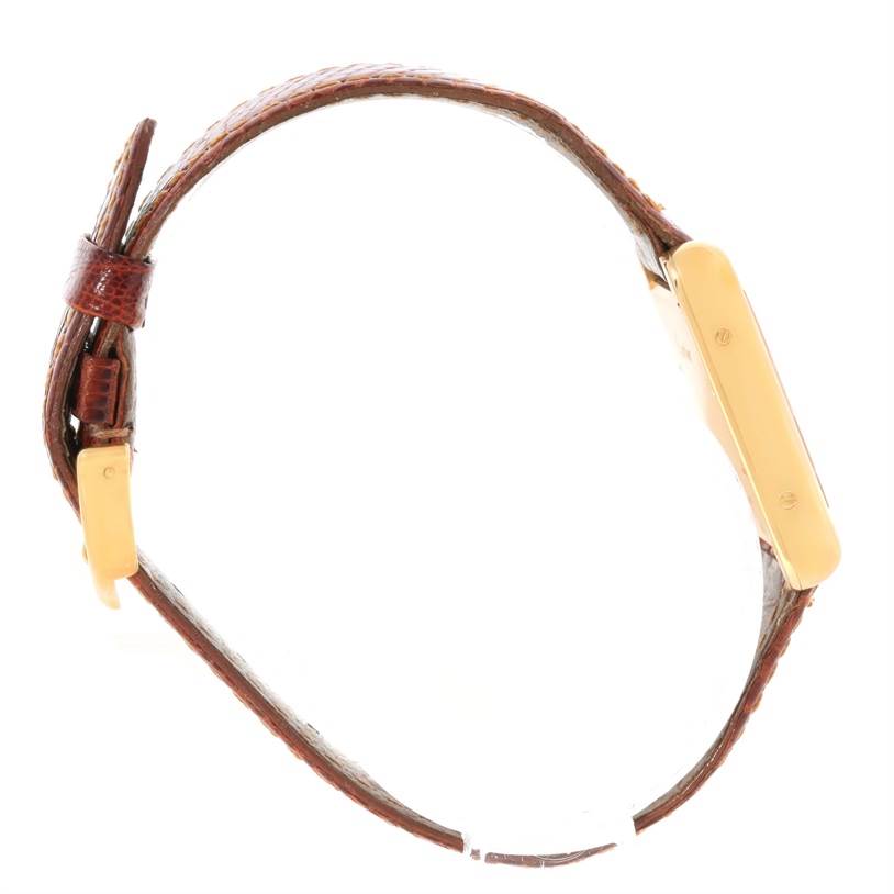 This image shows a side view of a Tank Louis model by Cartier, highlighting the brown leather strap and gold casing.