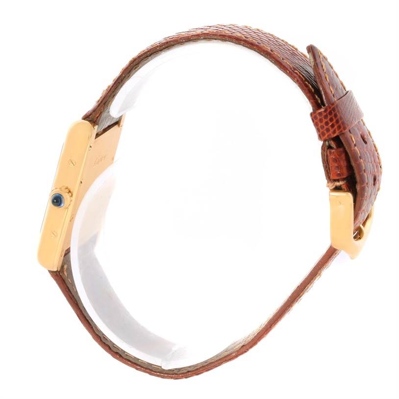 This is a side view of the Cartier Tank Louis W1529856 Women's Yellow Gold Silver Dial W1529856 Women's Yellow Gold Silver Dial model watch showing the strap, buckle, and winding crown.