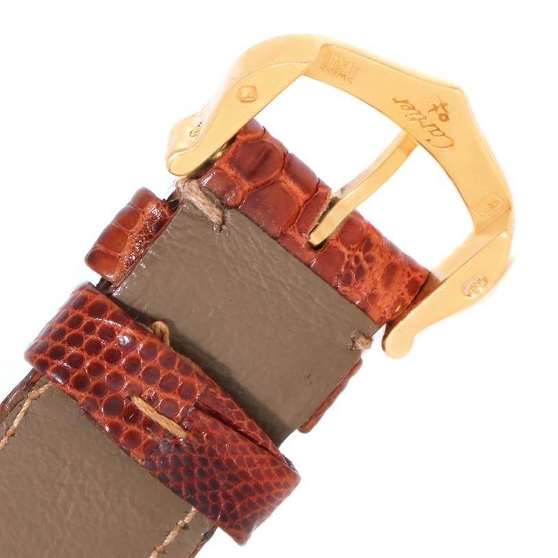 The image shows a close-up of the brown leather strap and gold buckle of a Cartier Tank Louis W1529856 Women's Yellow Gold Silver Dial W1529856 Women's Yellow Gold Silver Dial watch.