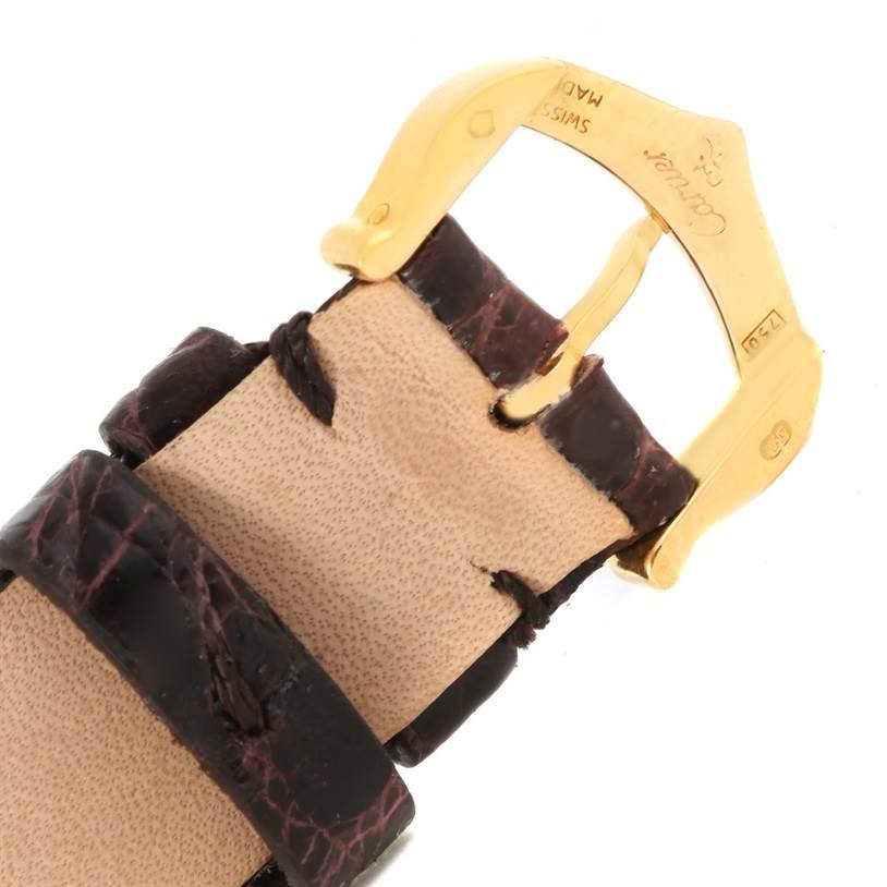 This is a close-up of the buckle and leather strap of a Tank Louis model watch by Cartier.