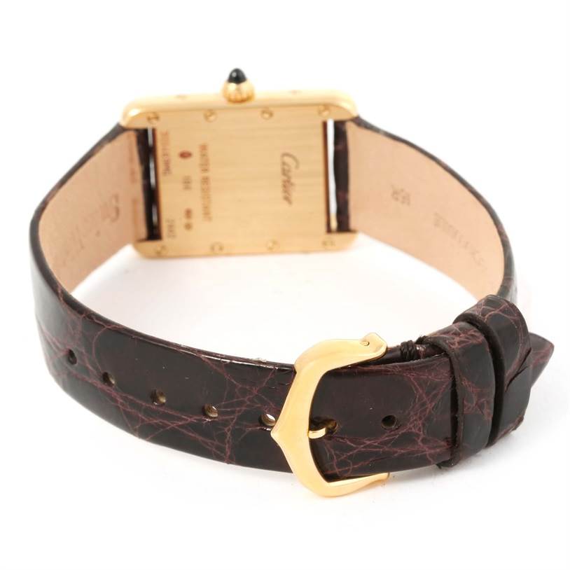 The image shows the back case, crown, and leather strap with buckle of a Cartier Tank Louis W1529856 Women's Yellow Gold Silver Dial W1529856 Women's Yellow Gold Silver Dial model watch.