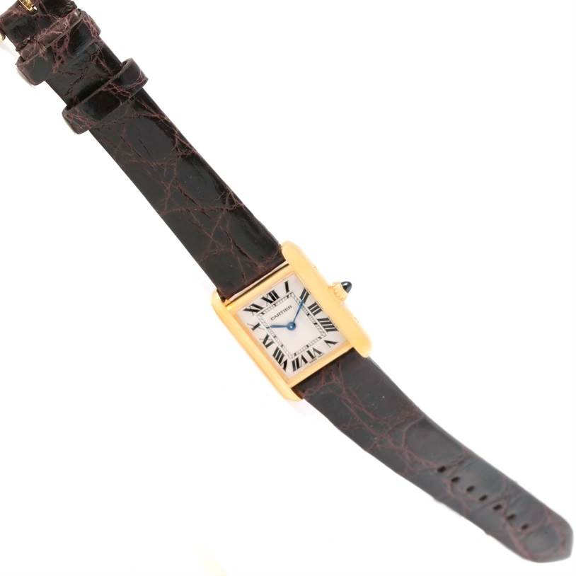 The image shows a Cartier Tank Louis W1529856 Women's Yellow Gold Silver Dial W1529856 Women's Yellow Gold Silver Dial watch from an angled top view, highlighting the face, strap, and crown.