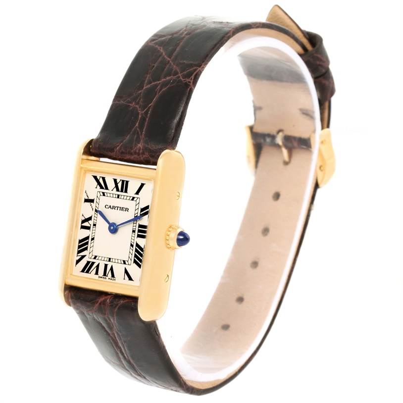The Tank Louis Cartier watch is shown from an angled view displaying its face, crown, and leather strap.