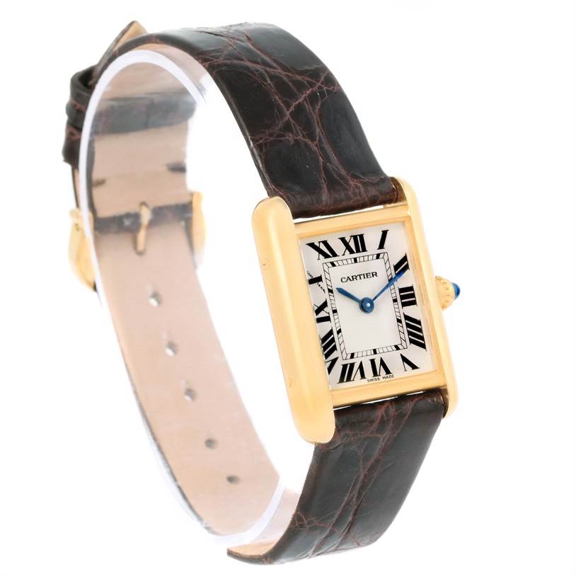 The image shows a Tank Louis model by Cartier at a slight angle, displaying the face, bezel, crown, and leather strap.