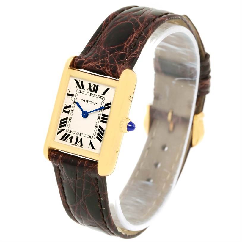 The Cartier Tank Louis W1529856 Women's Yellow Gold Silver Dial W1529856 Women's Yellow Gold Silver Dial watch is shown from an angled perspective, highlighting the face, bezel, and leather strap.