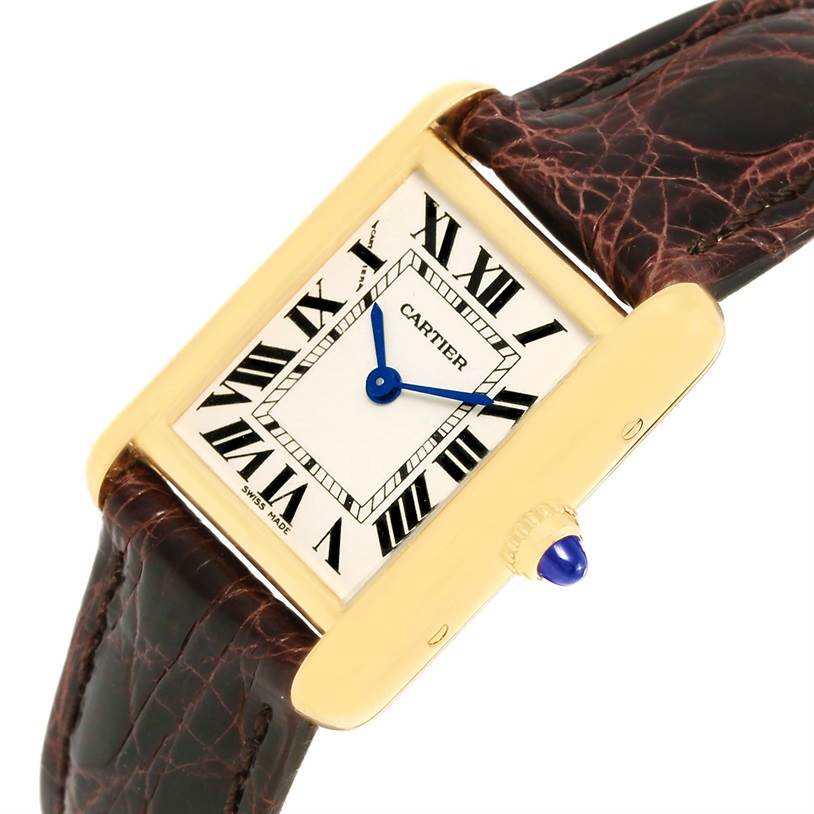 The image shows a Tank Louis model watch by Cartier at a slight angle, highlighting its rectangular face, Roman numeral markers, and leather strap.