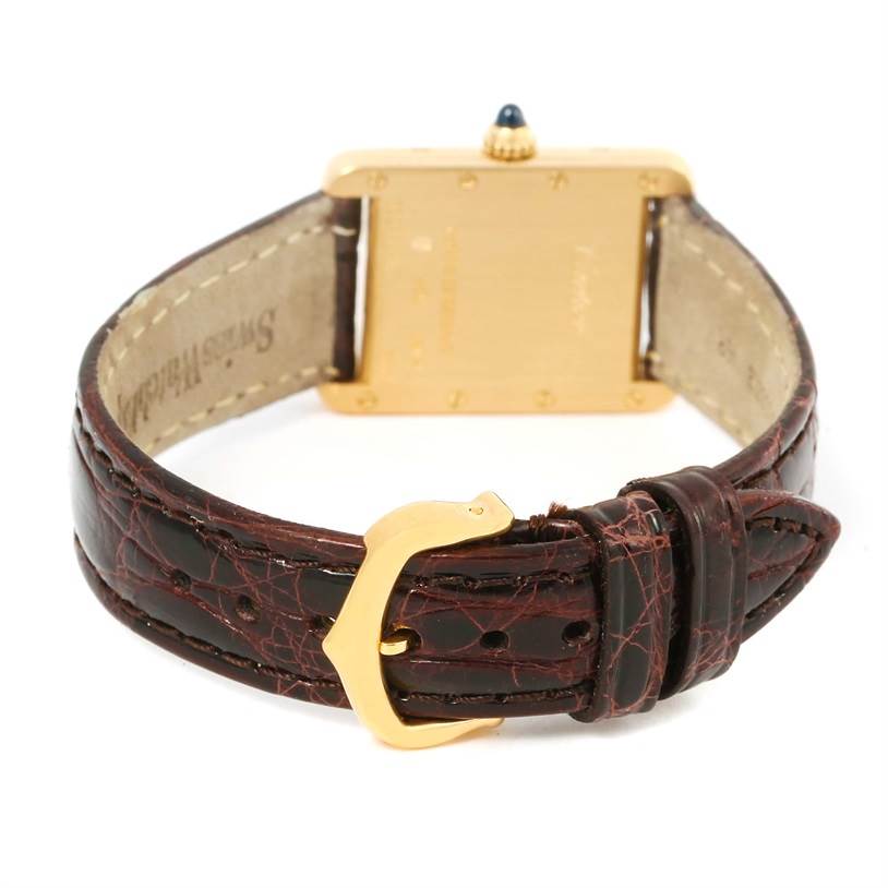 This image shows the back view of a Cartier Tank Louis W1529856 Women's Yellow Gold Silver Dial W1529856 Women's Yellow Gold Silver Dial watch, highlighting its gold casing and leather strap with a buckle.