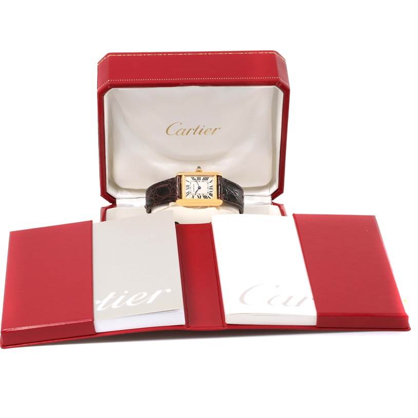 The Cartier Tank Louis W1529856 Women's Yellow Gold Silver Dial W1529856 Women's Yellow Gold Silver Dial watch is shown front-facing in its red and white box with accompanying booklets.