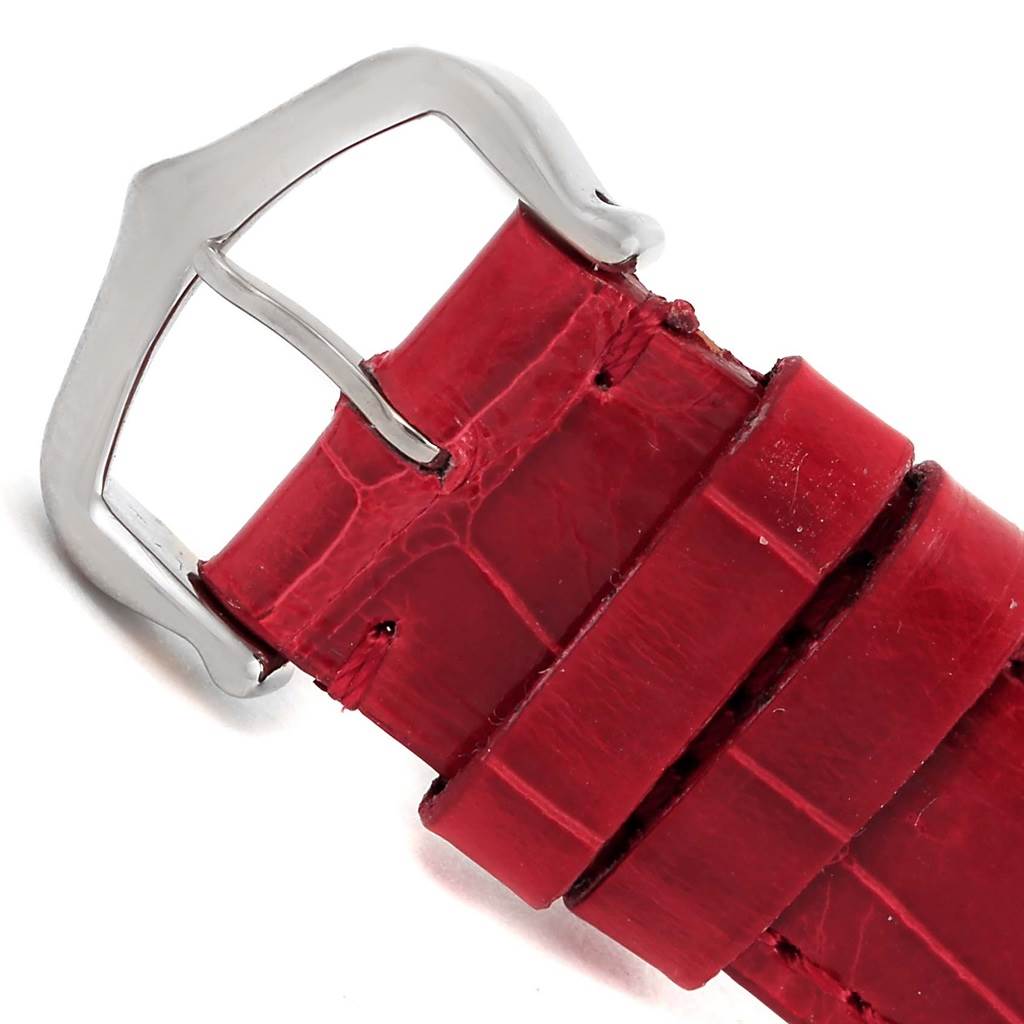 The image shows a close-up of the red leather strap and silver buckle of a Cartier Tank Louis W1540956 White Gold Silver Dial W1540956 White Gold Silver Dial watch.