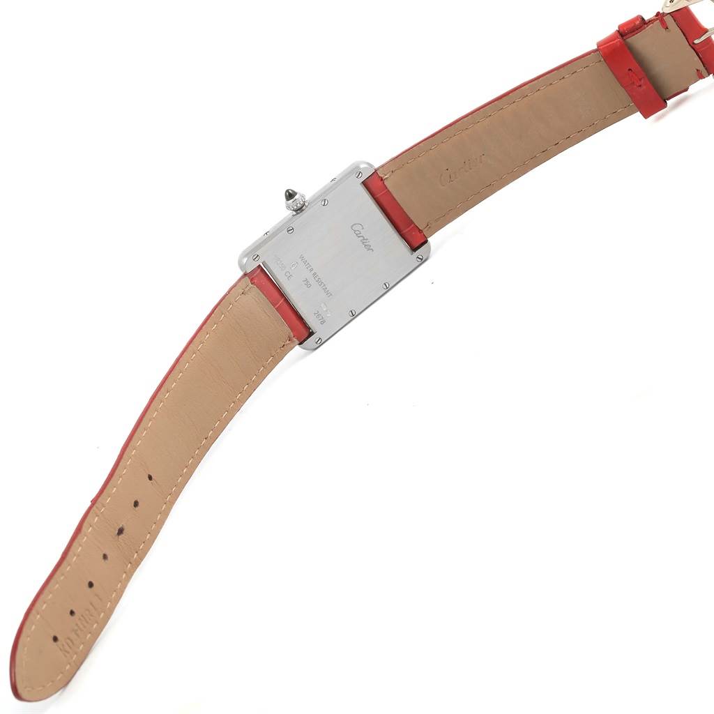 This image shows the back of a Tank Louis model watch by Cartier, focusing on the case back and leather strap.