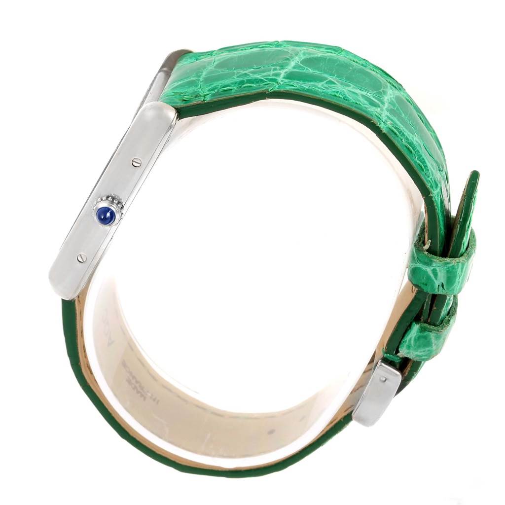 Side view of the Tank Louis model by Cartier, showing the crown, case, and green leather strap.