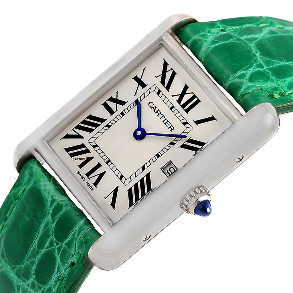 This image shows a close-up, angled view of the face and side crown of the Tank Louis Cartier watch, featuring a rectangular dial, Roman numerals, and a green strap.