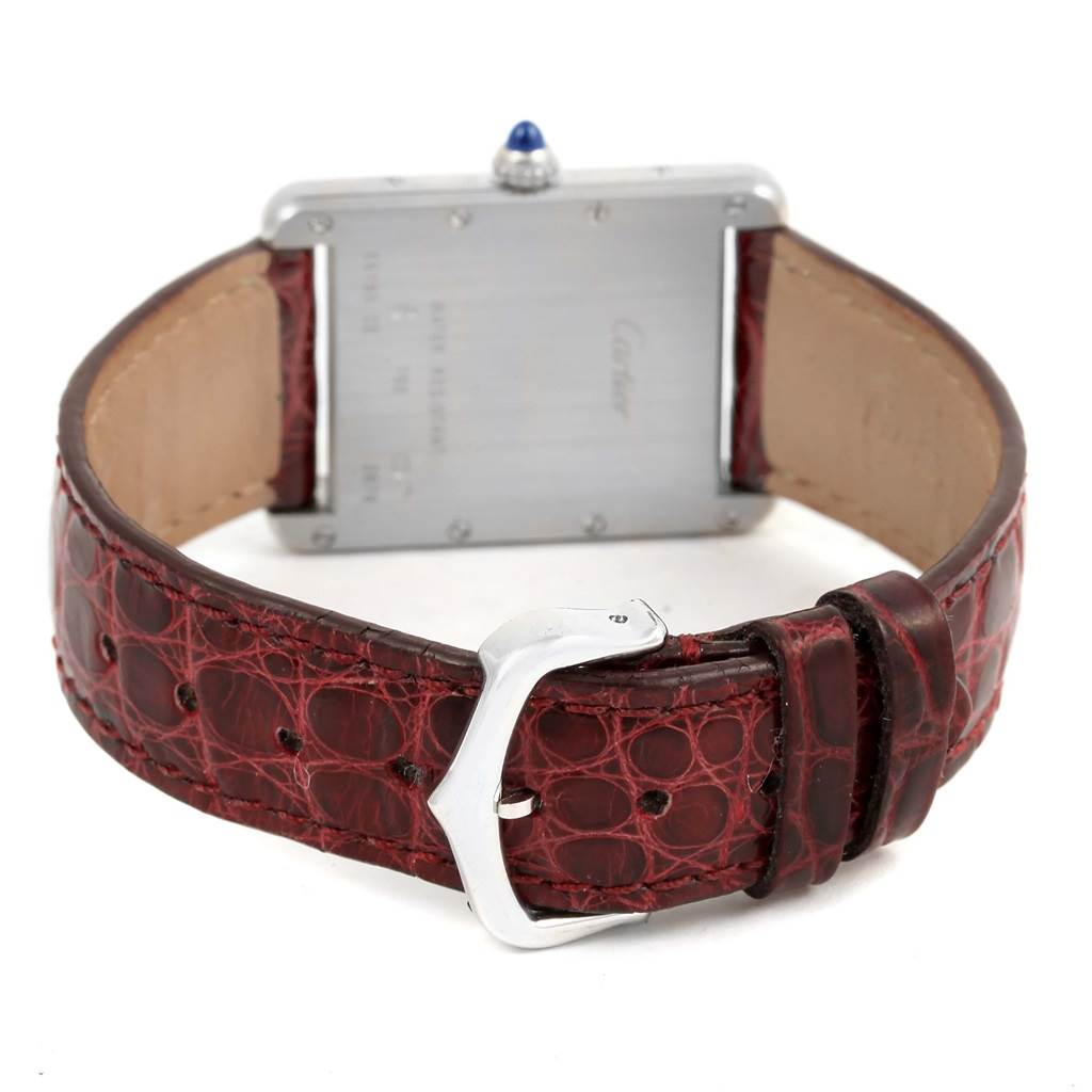 The image shows the back view of a Cartier Tank Louis W1540956 White Gold Silver Dial W1540956 White Gold Silver Dial watch, highlighting its red leather strap and clasp.