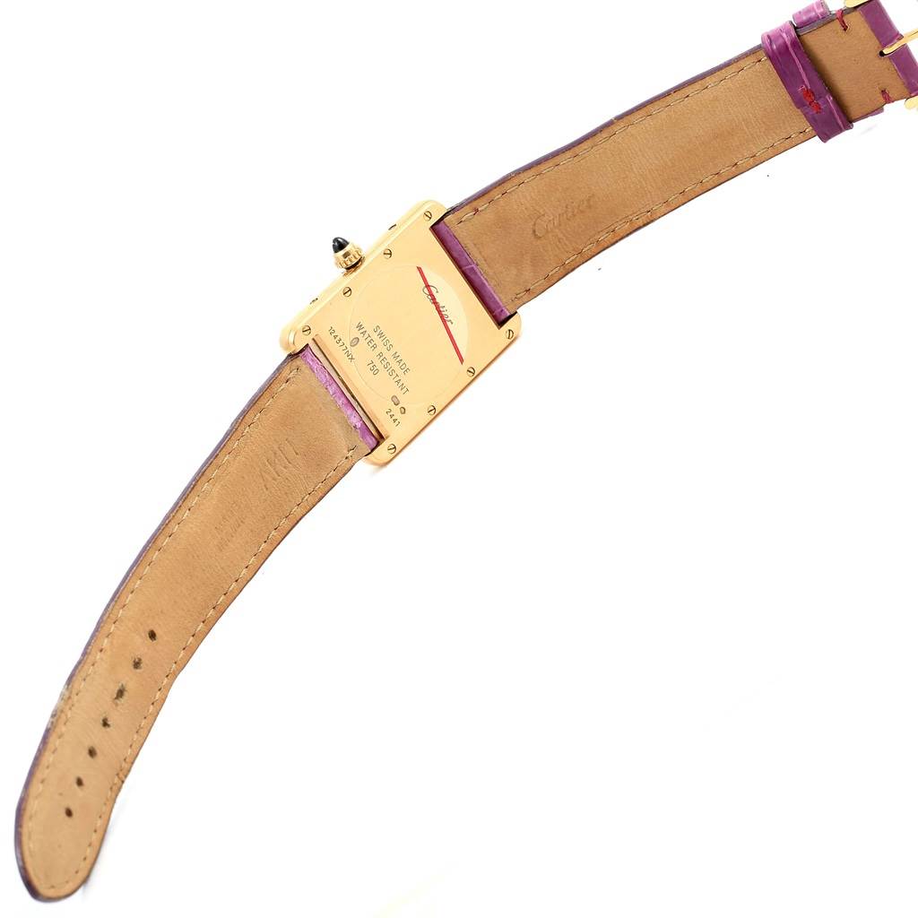 This image shows the back case and leather strap of a Cartier Tank Louis W1529756 Yellow Gold Silver Dial W1529756 Yellow Gold Silver Dial watch, highlighting the engravings and clasp.