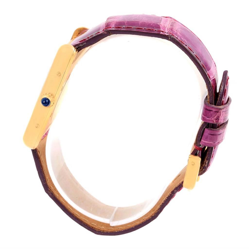 The image shows a side profile of the Cartier Tank Louis W1529756 Yellow Gold Silver Dial W1529756 Yellow Gold Silver Dial watch, highlighting the purple strap and gold casing.