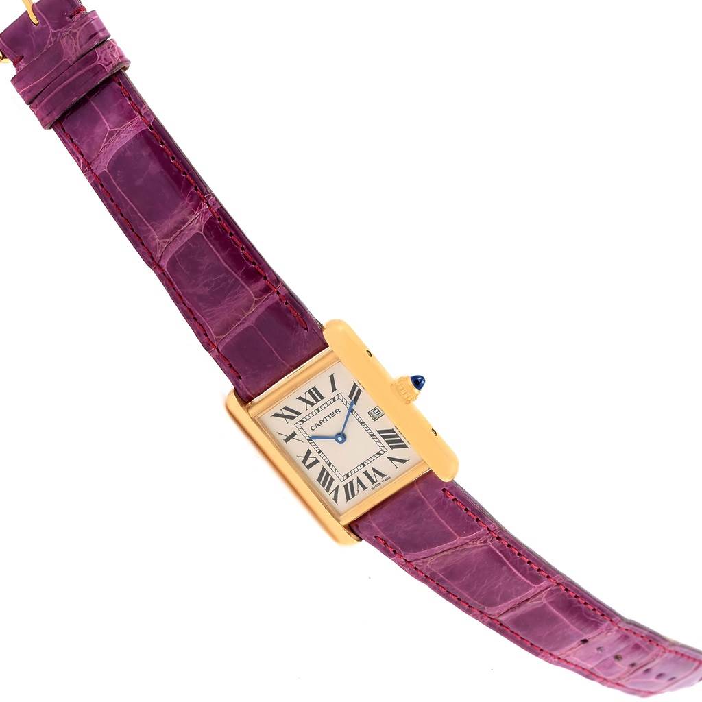 This image shows a Tank Louis model by Cartier at an angled top view, displaying the watch face, case, crown, and purple leather strap.