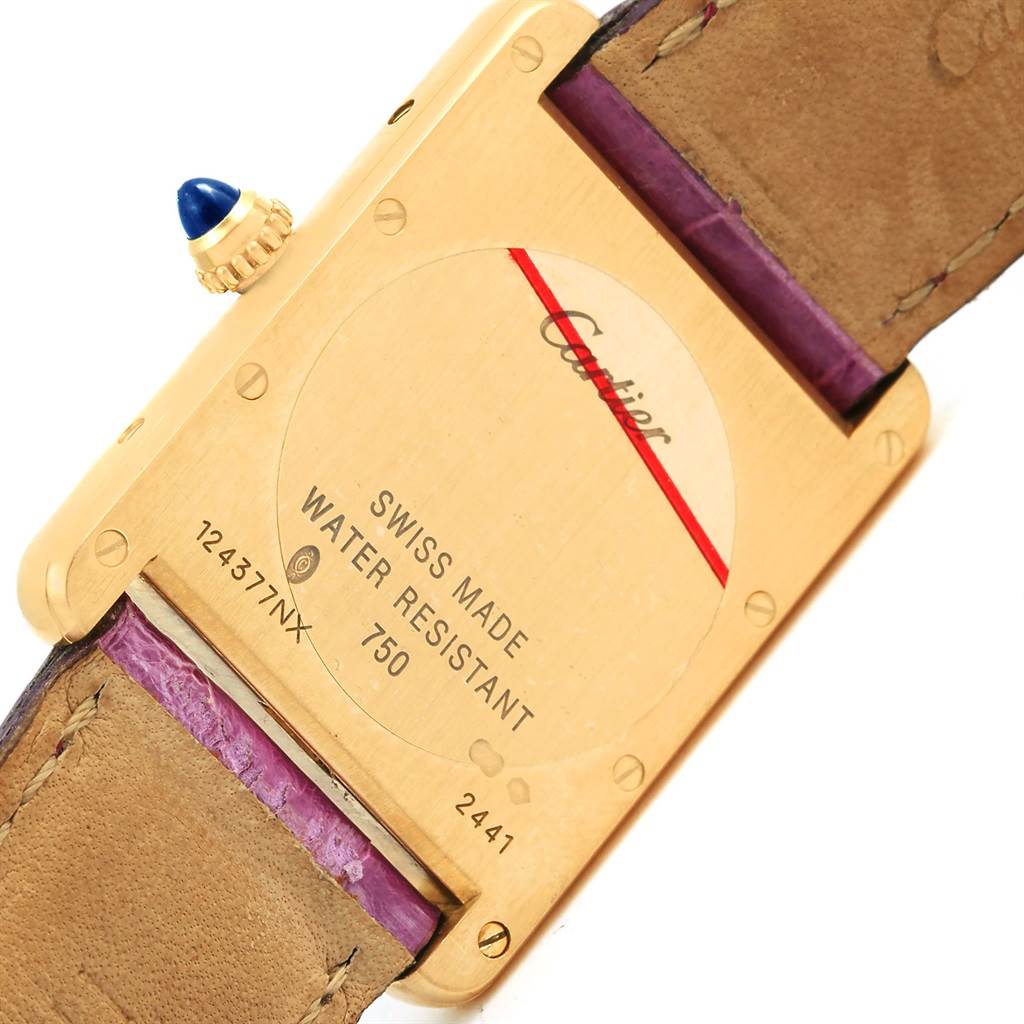 The image shows the back case and leather strap of a Cartier Tank Louis W1529756 Yellow Gold Silver Dial W1529756 Yellow Gold Silver Dial watch with inscriptions detailing its specifications.