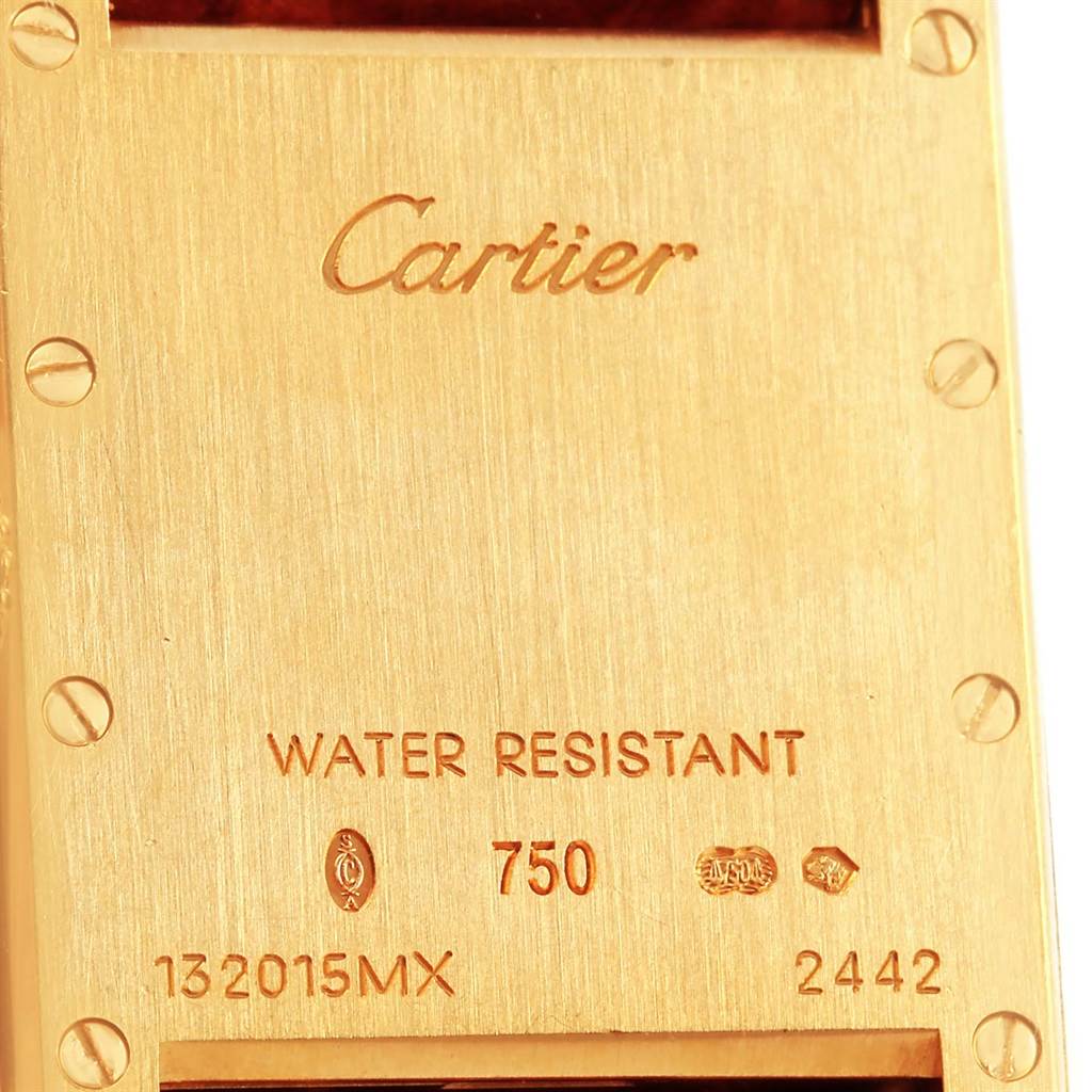This image shows the back of a Tank Louis model by Cartier, displaying engravings and serial numbers.