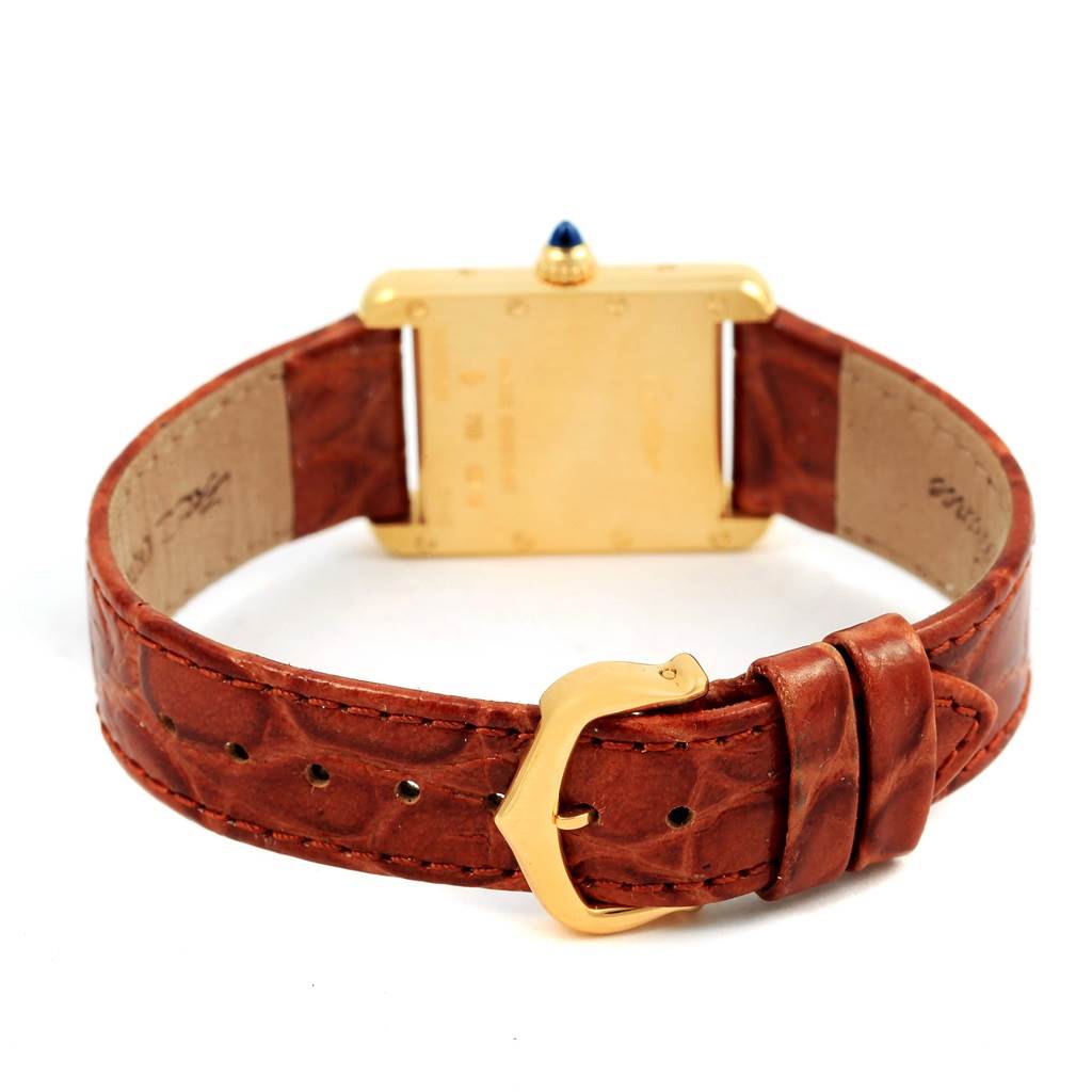 The image shows the back view of the Cartier Tank Louis W1529856 Women's Yellow Gold Silver Dial W1529856 Women's Yellow Gold Silver Dial watch, highlighting its leather strap and gold buckle.