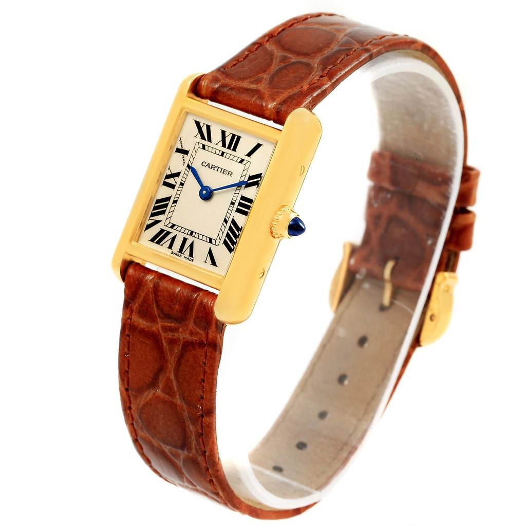 This image shows a Cartier Tank Louis W1529856 Women's Yellow Gold Silver Dial W1529856 Women's Yellow Gold Silver Dial model watch at a slight angle, highlighting its rectangular face, Roman numerals, leather strap, and crown.