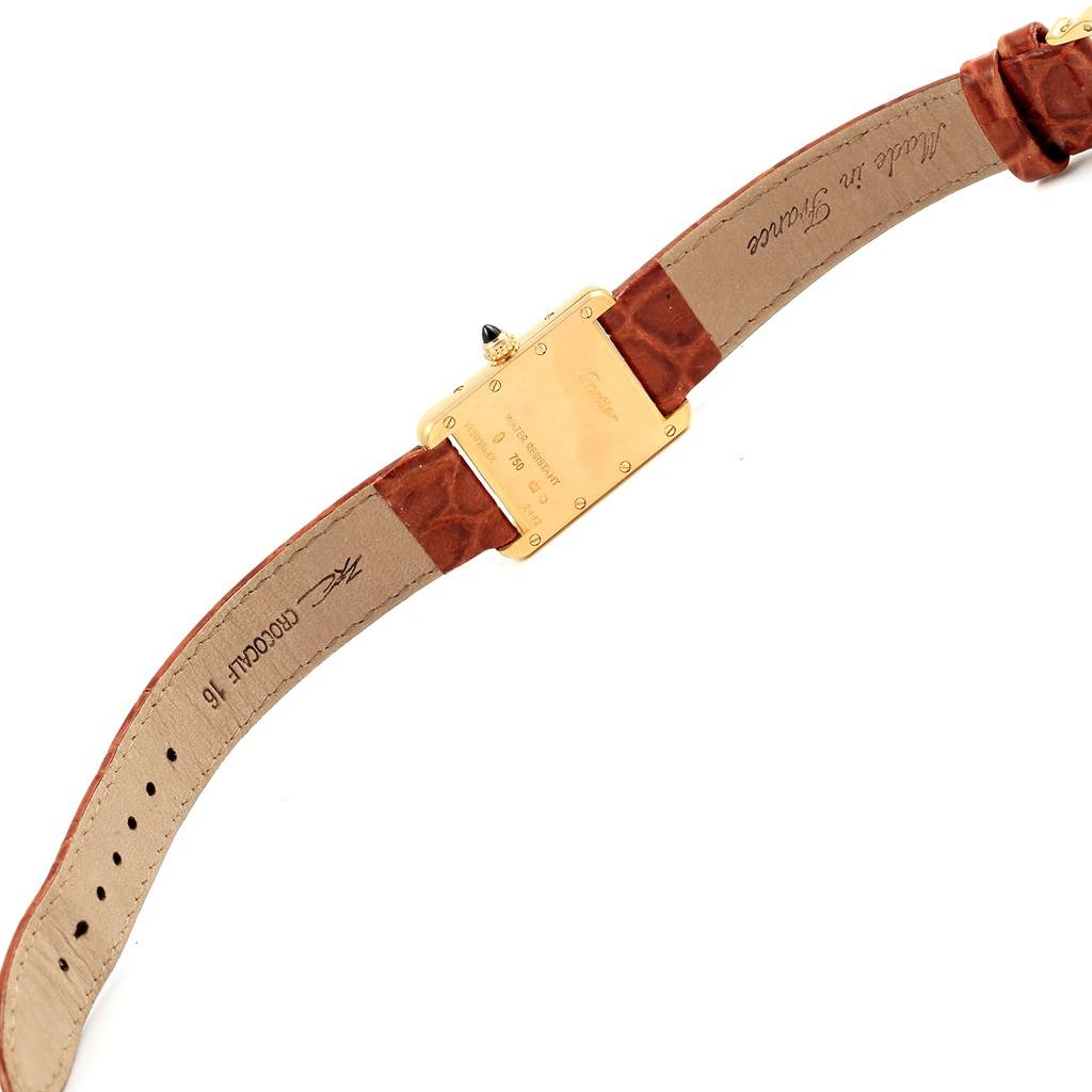 The image shows the back of the Tank Louis model by Cartier, displaying the case back and brown leather strap.