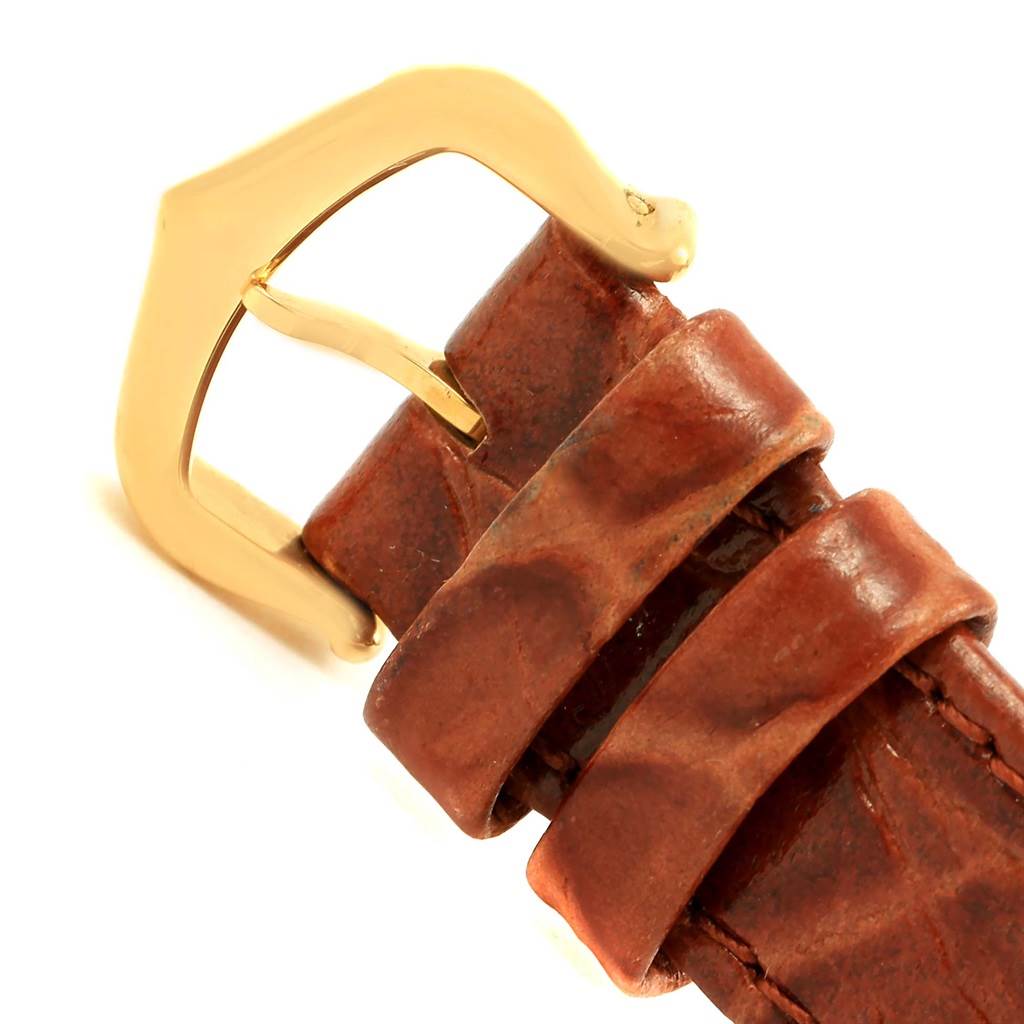 This image shows a close-up of the brown leather strap and gold buckle of a Cartier Tank Louis W1529856 Women's Yellow Gold Silver Dial W1529856 Women's Yellow Gold Silver Dial watch.