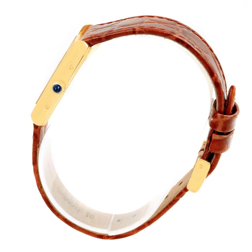 This image shows a side view of a Cartier Tank Louis W1529856 Women's Yellow Gold Silver Dial W1529856 Women's Yellow Gold Silver Dial watch, focusing on the gold case and brown leather strap.