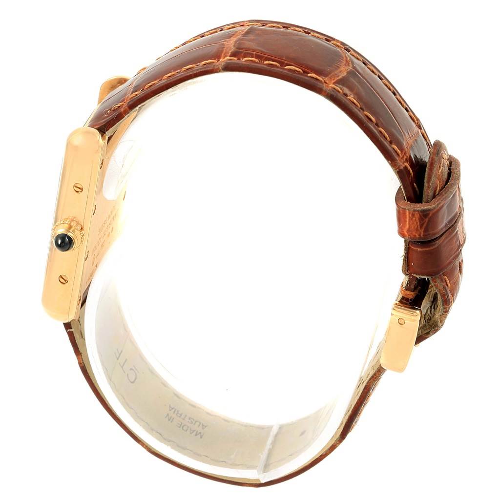 The Cartier Tank Louis W1529856 Women's Yellow Gold Silver Dial W1529856 Women's Yellow Gold Silver Dial watch is shown from a top-down side angle, highlighting the strap, case, and crown.