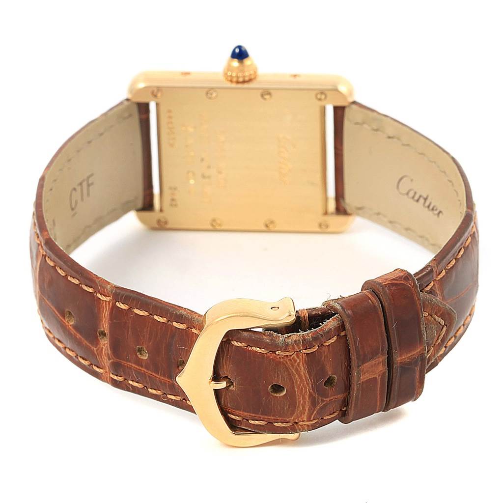 The image shows the back and leather strap of a Tank Louis model by Cartier.