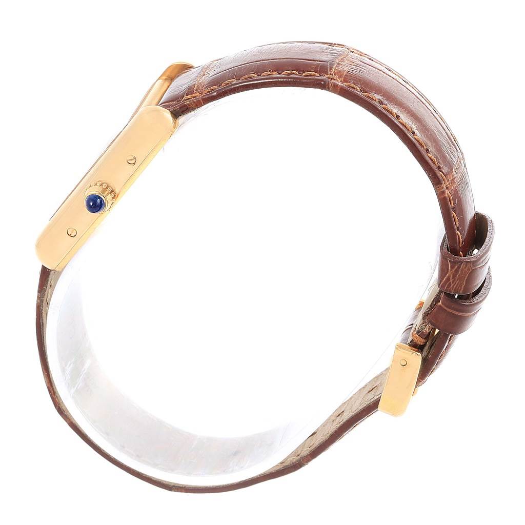 This side angle view of the Cartier Tank Louis W1529856 Women's Yellow Gold Silver Dial W1529856 Women's Yellow Gold Silver Dial watch shows the crown and leather strap.