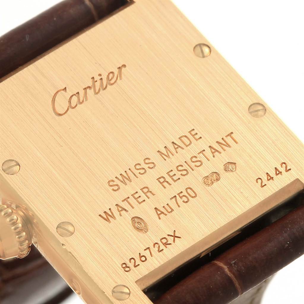 This image shows the back of a Tank Louis model by Cartier, detailing its engravings and a portion of the leather strap.