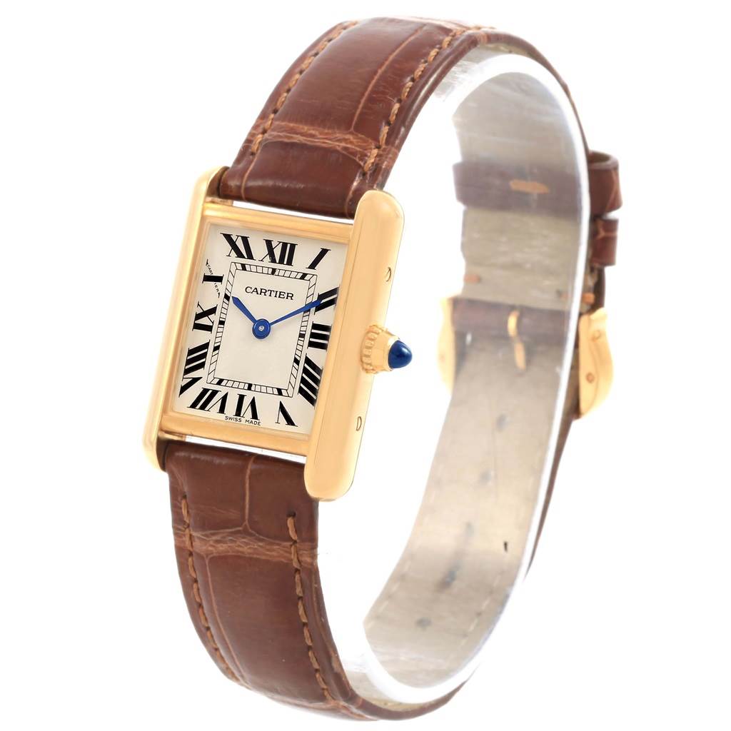 The Tank Louis model by Cartier is shown at an angled side view, highlighting its gold case, blue hands, Roman numeral dial, and brown leather strap.