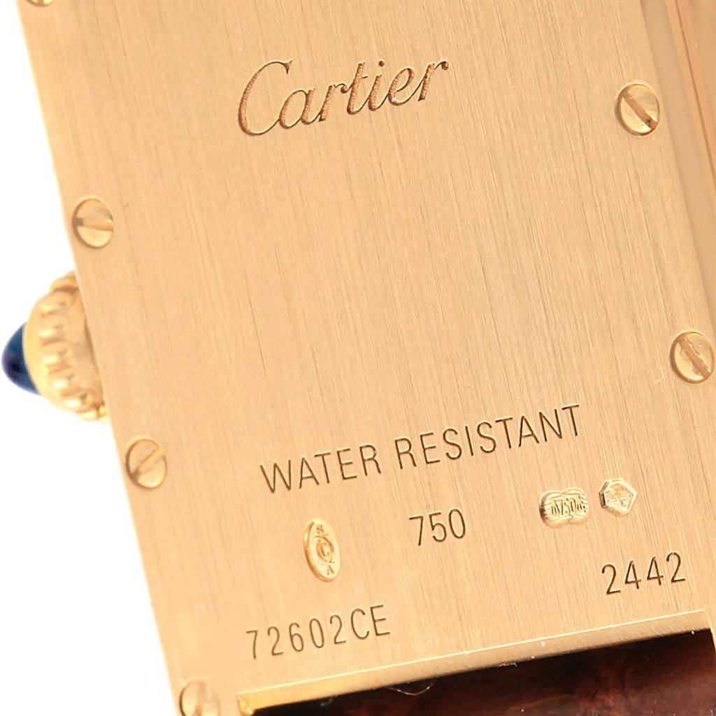 This image shows the back case of a Cartier Tank Louis W1529856 Women's Yellow Gold Silver Dial W1529856 Women's Yellow Gold Silver Dial watch, highlighting its water resistance, serial number, and brand engravings.