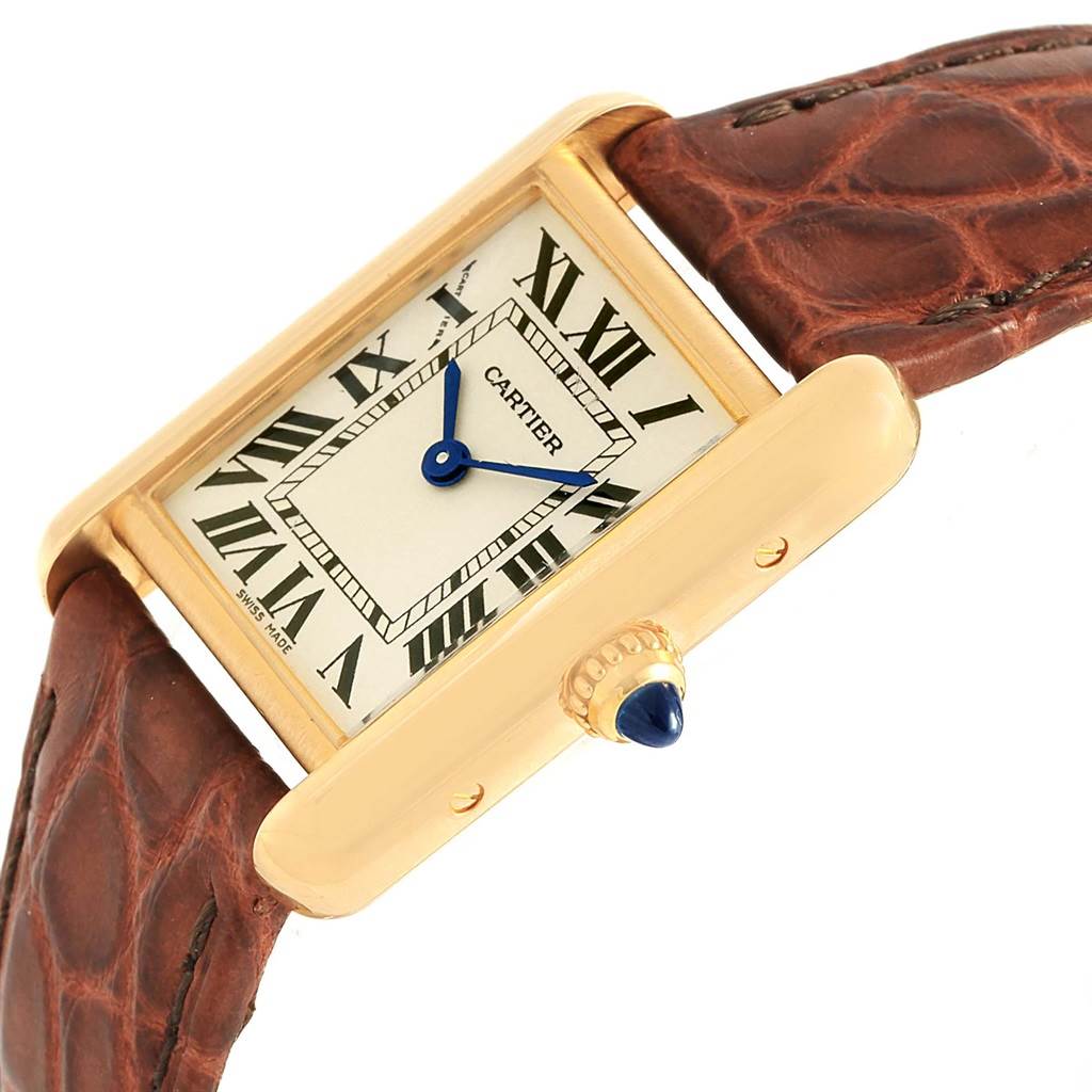 The image shows a Cartier Tank Louis W1529856 Women's Yellow Gold Silver Dial W1529856 Women's Yellow Gold Silver Dial watch at an angle revealing the face, crown, and part of the brown leather strap.