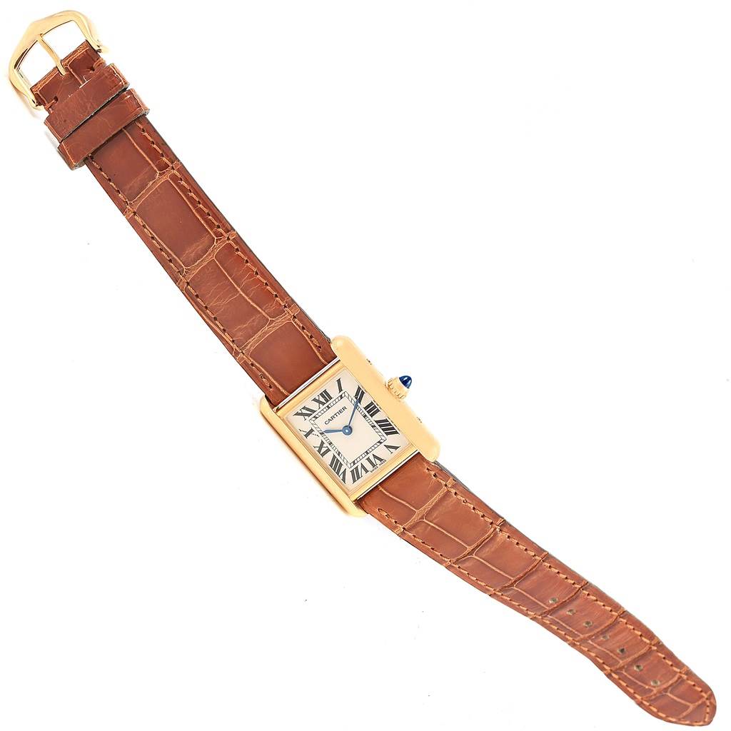 The image shows a top-down view of a Cartier Tank Louis W1529856 Women's Yellow Gold Silver Dial W1529856 Women's Yellow Gold Silver Dial watch with a brown leather strap and rectangular gold case.