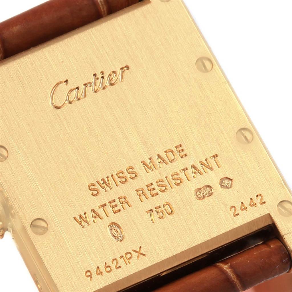 The image shows the back case and part of the leather strap of a Cartier Tank Louis W1529856 Women's Yellow Gold Silver Dial W1529856 Women's Yellow Gold Silver Dial watch.