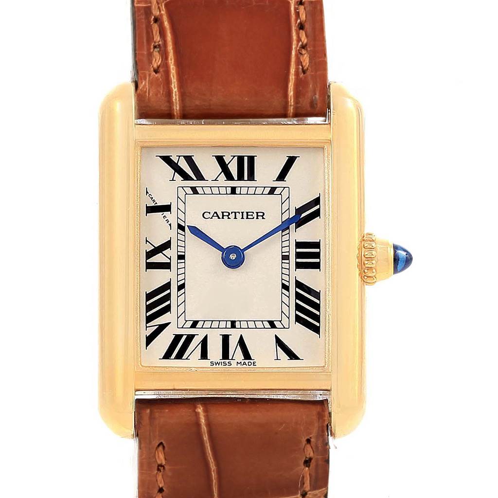 The image shows a frontal view of the Cartier Tank Louis W1529856 Women's Yellow Gold Silver Dial W1529856 Women's Yellow Gold Silver Dial watch, highlighting its dial, Roman numerals, blue hands, and brown leather strap.