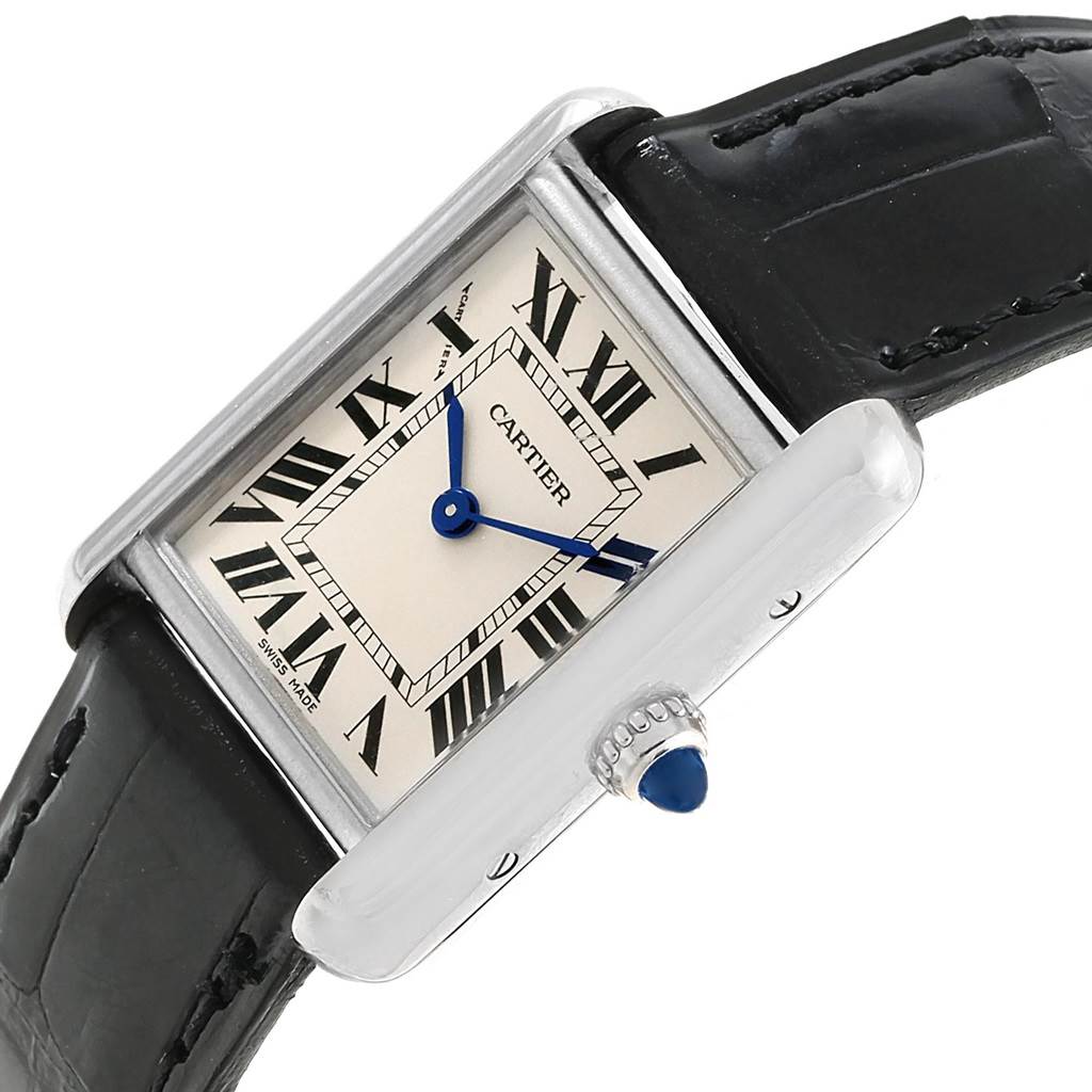 The image shows a Cartier Tank Louis W1541056 Women's White Gold Silver Dial W1541056 Women's White Gold Silver Dial watch at an angled view, highlighting the face, black leather strap, and blue hands and crown jewel.