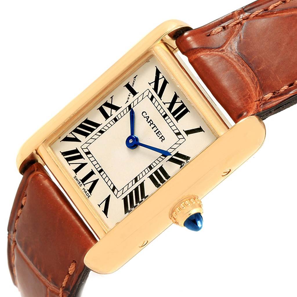 The image shows a close-up angled view of the Cartier Tank Louis W1529856 Women's Yellow Gold Silver Dial W1529856 Women's Yellow Gold Silver Dial watch face, brown leather strap, and the gold crown with a blue cabochon.