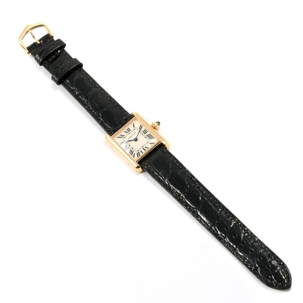 This image shows a Tank Louis model by Cartier from a top-down angle, displaying its entire face, case, and black leather strap.