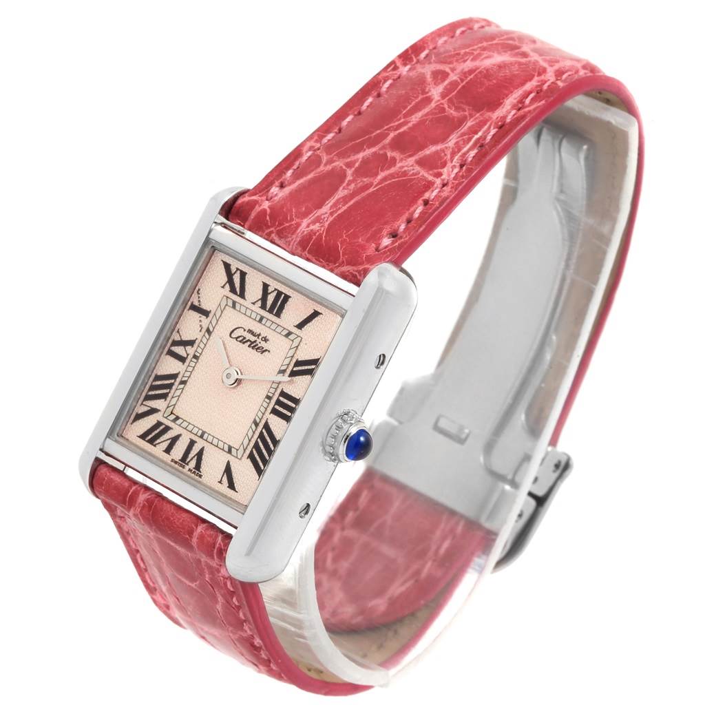 The image shows a Cartier Tank Louis 8129 Women's Stainless Steel Pink Dial 8129 Women's Stainless Steel Pink Dial watch at an angle highlighting its face, crown, and red leather strap.