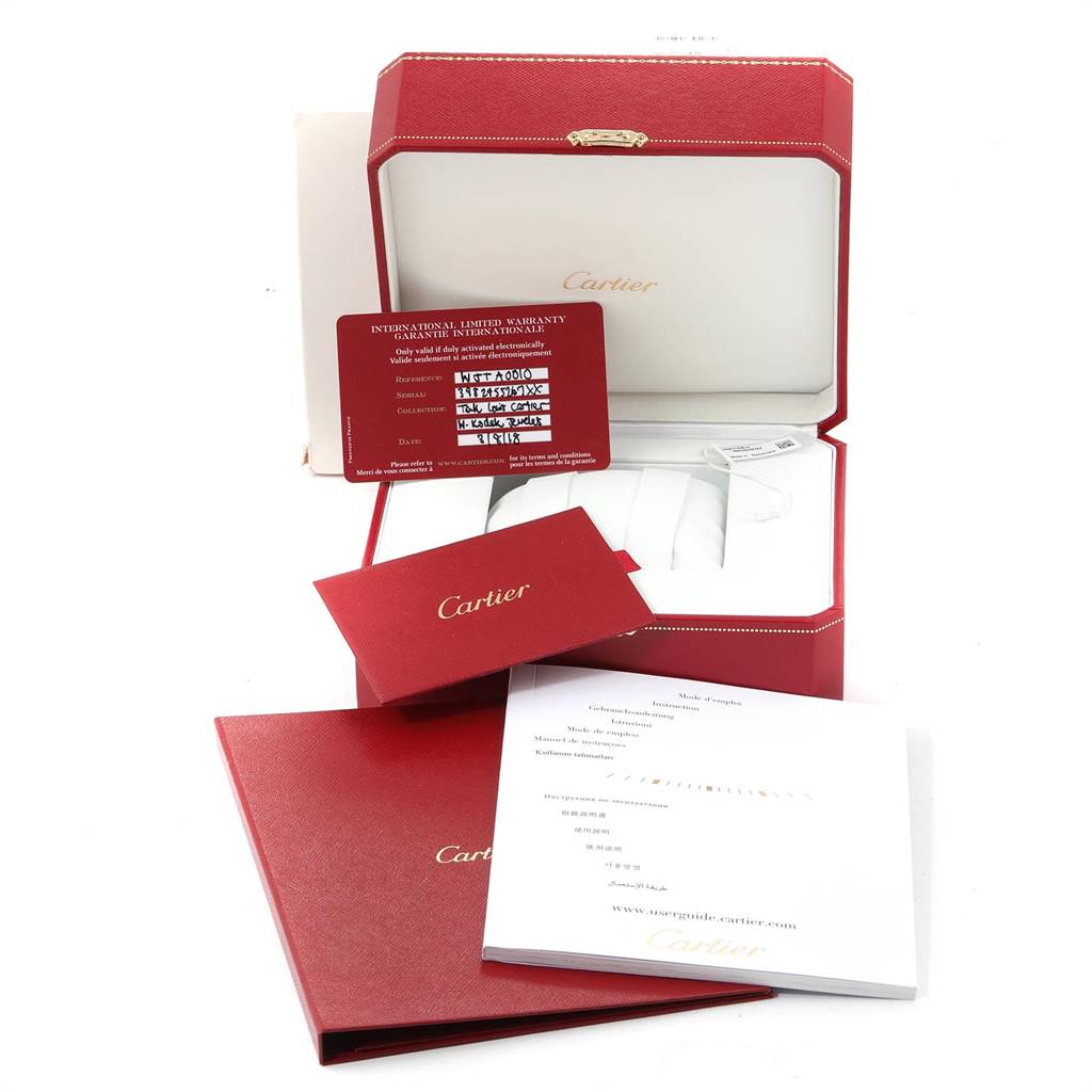 The image shows the packaging and accessories, including the box, manuals, and warranty card for the Cartier Tank Louis WJTA0010 Women's Yellow Gold Silver Dial WJTA0010 Women's Yellow Gold Silver Dial model watch.
