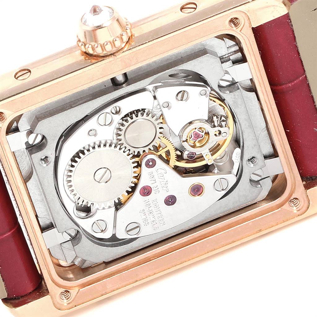 The image shows a close-up of the movement and internal mechanism of a Cartier Tank Louis WJTA0010 Women's Yellow Gold Silver Dial WJTA0010 Women's Yellow Gold Silver Dial watch, focusing on the gears and components.