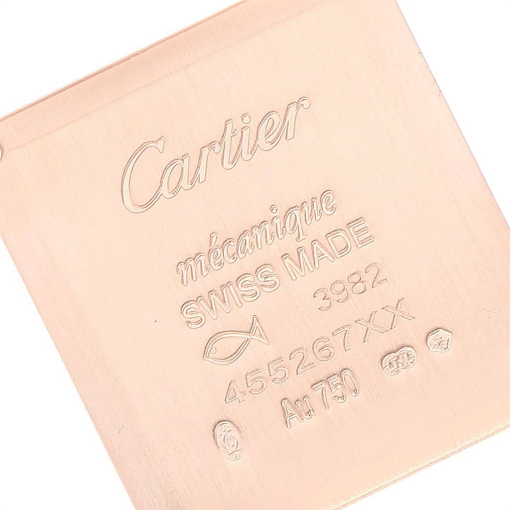 This is a close-up image of the back case of a Tank Louis model watch by Cartier, showing the engravings and markings.