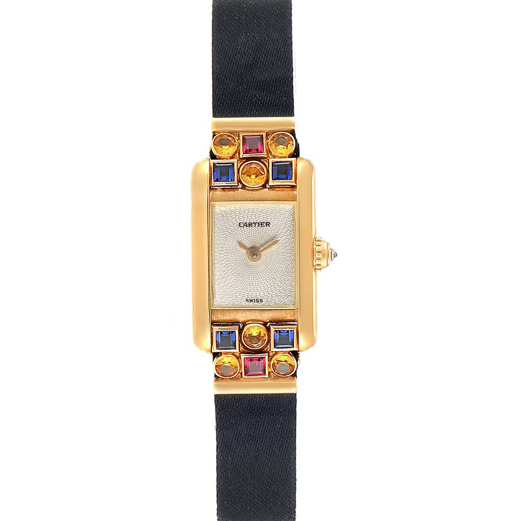 The image shows a front view of the Cartier Tank Louis 1360 Women
s Yellow Gold Silver Dial 1360 Women
s Yellow Gold Silver Dial watch, highlighting its rectangular face, gold frame, gem accents, and black strap.