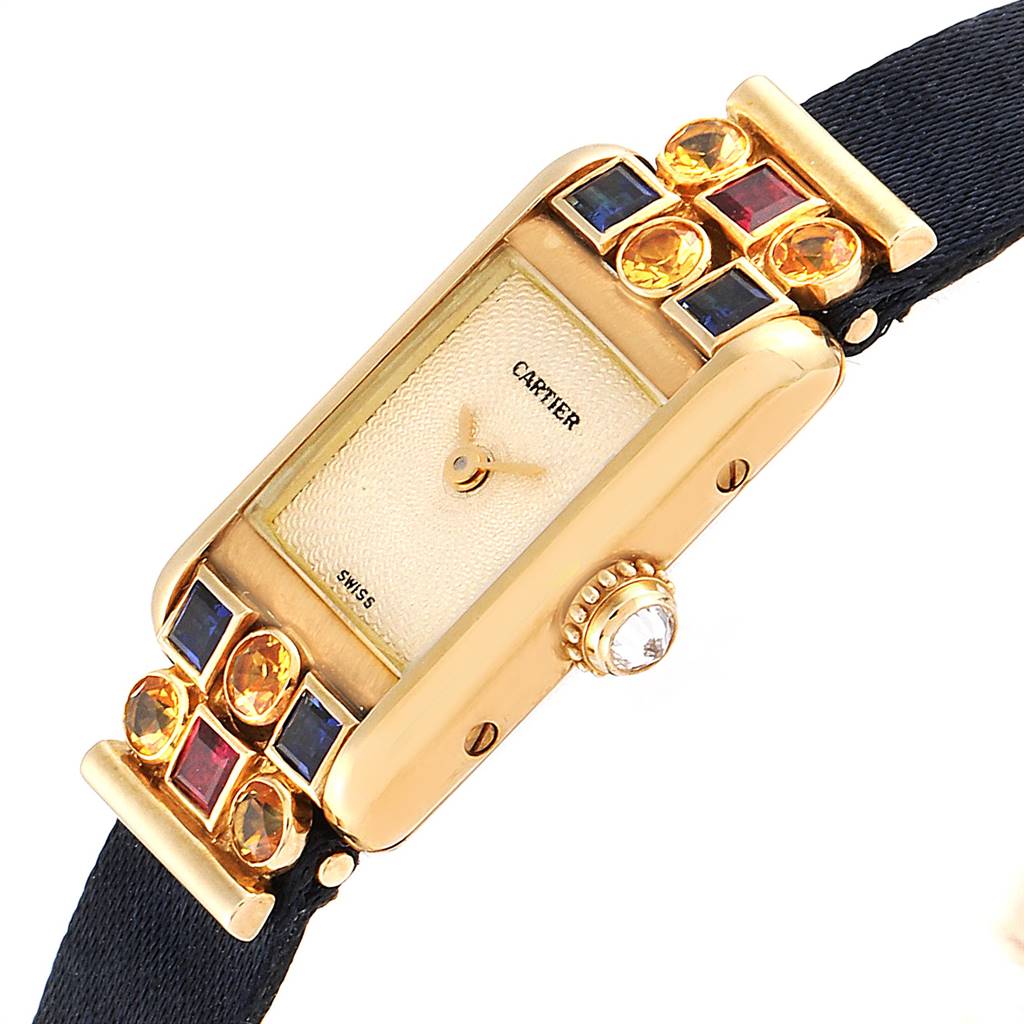 This image shows a close-up angle of the dial and strap of a Cartier Tank Louis 1360 Women
s Yellow Gold Silver Dial 1360 Women
s Yellow Gold Silver Dial model watch, highlighting the gemstones and crown.